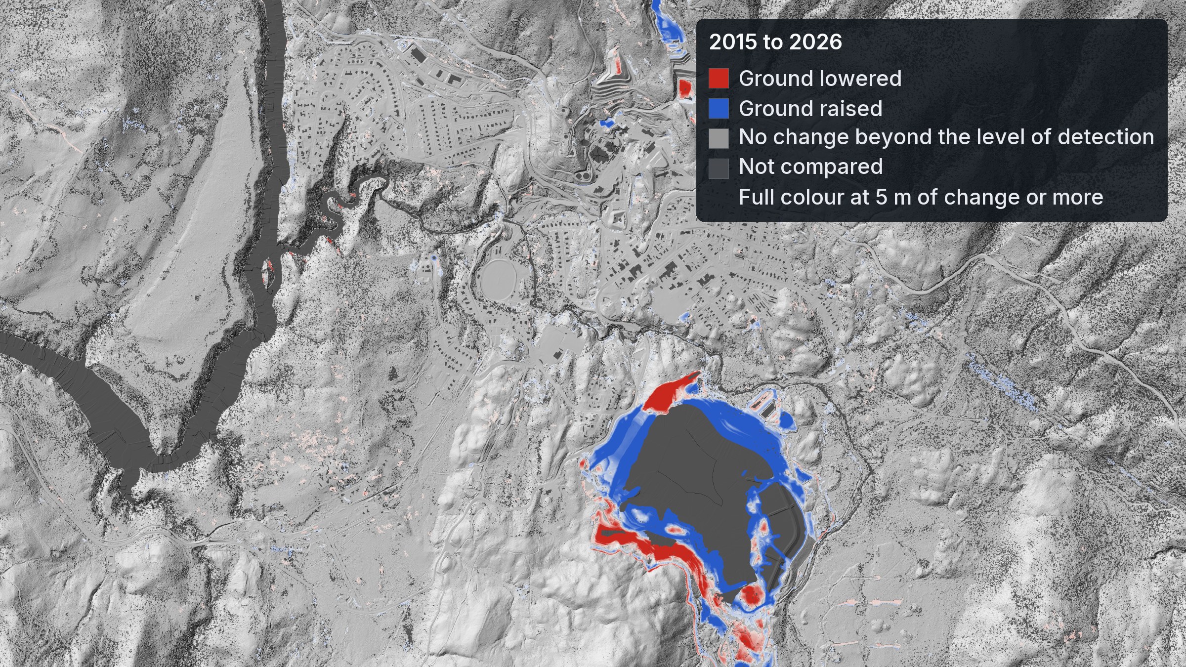 Rosebery, Tasmania: the 2026 bare-earth relief, with ground lowered (red) and raised (blue) between the 2015 and 2026 surveys beyond the level of detection, nine-tenths of it in one area south of the town. West Coast 2015 and Rosebery 2026 LiDAR, Fire History and TASVEG: theLIST © State of Tasmania, CC BY 3.0 AU. No affiliation with the operator.